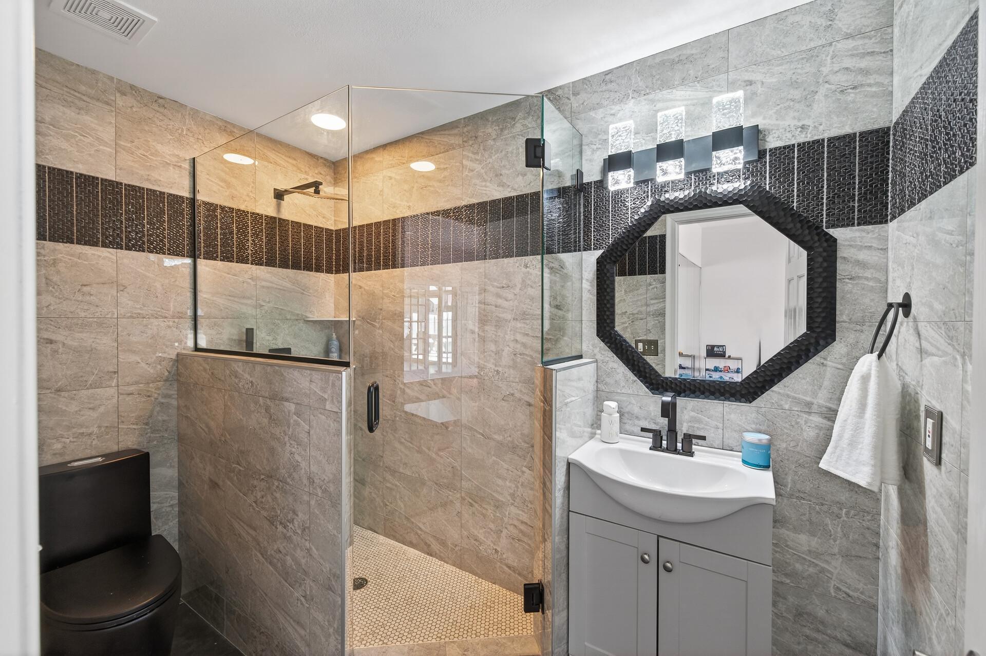 The exercise room also includes a private three-quarter bathroom with a walk-in shower.