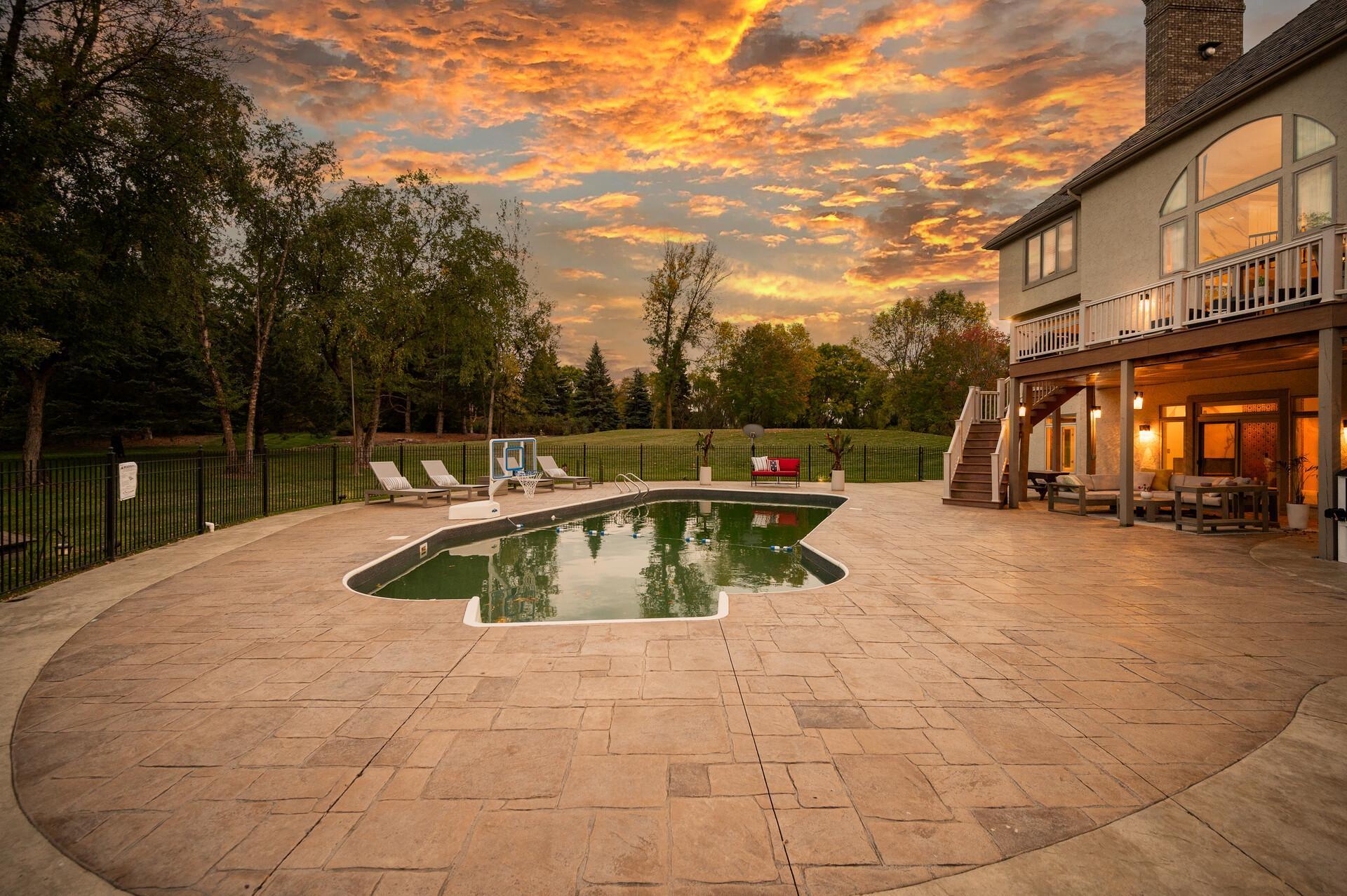 The exceptional backyard is designed for outdoor enjoyment, offering a fully fenced pool deck with an in-ground heated pool.