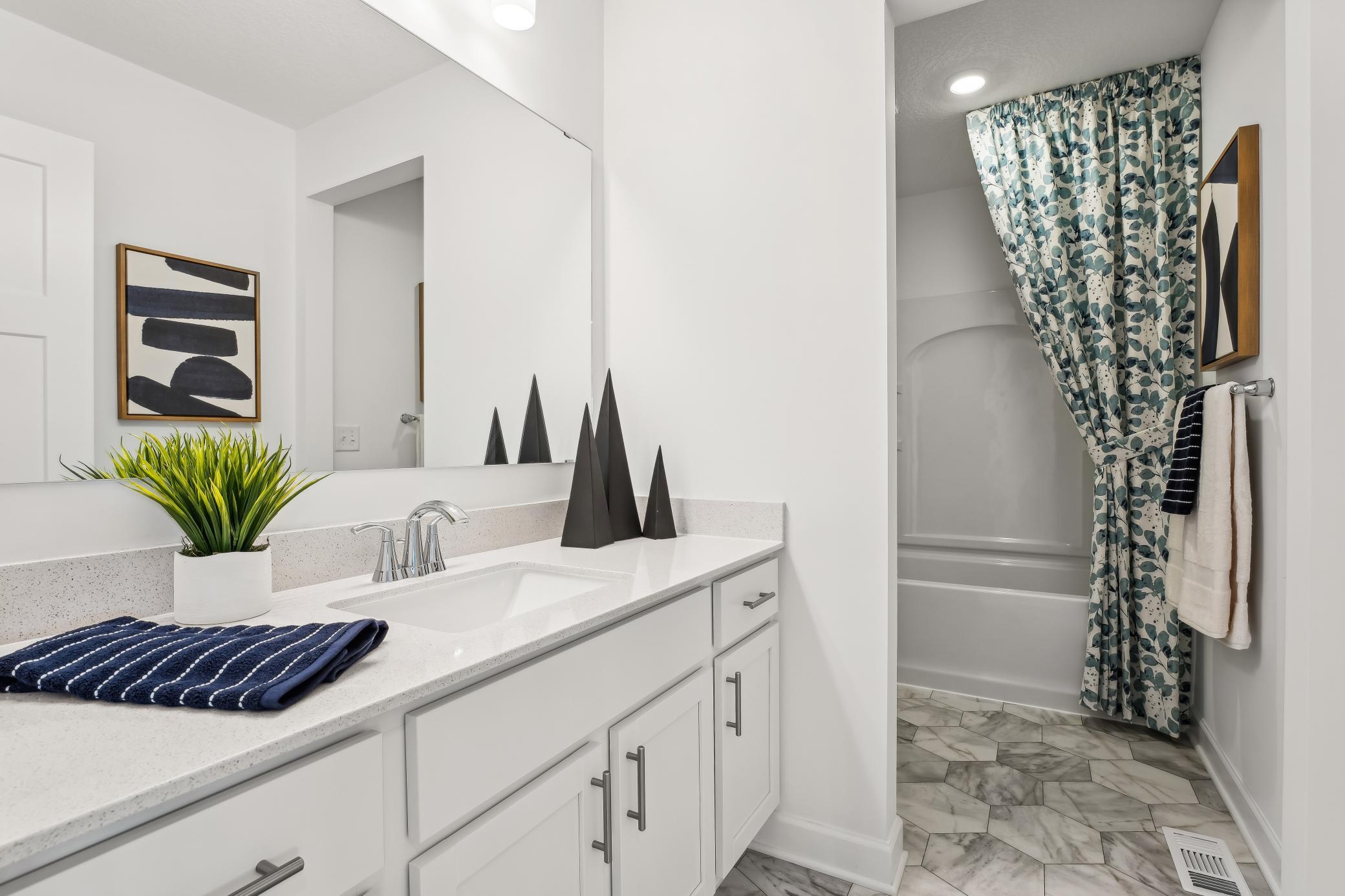 (Photos of model home, features will vary) This full bathroom is conveniently located on the second floor and showcases dual sinks and a shower-tub combination.