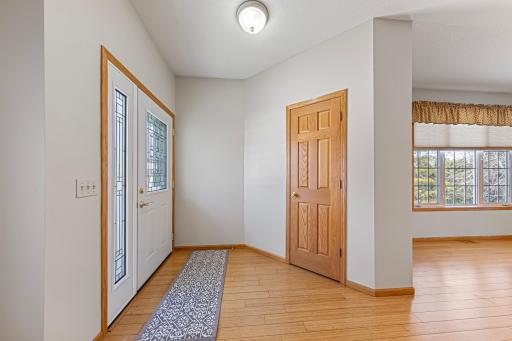 Updated front entry door and spacious closet featuring six-panel solid interior door