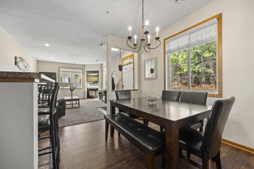 An open-concept layout flows seamlessly into the dining area, highlighted by statement lighting.
