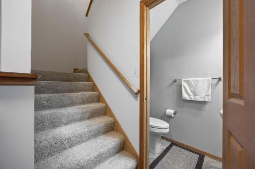 Additional main-level conveniences include a spacious hall closet, a powder room, and direct access to the attached 2-car garage.