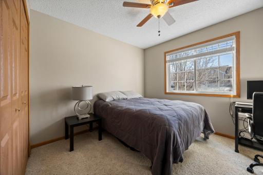 The upper level also features two well-sized bedrooms with comfortable carpeting and ceiling fans.