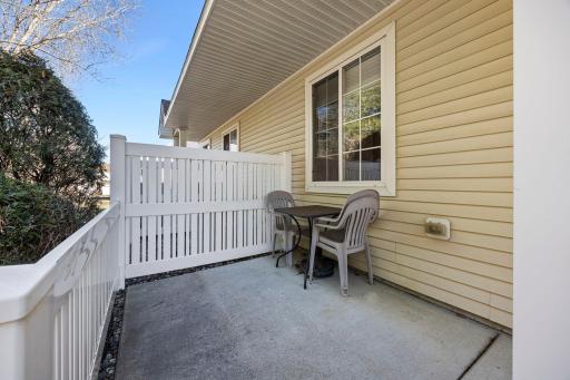 Enjoy the relaxing front patio, complemented by a steep embankment that provides added privacy.