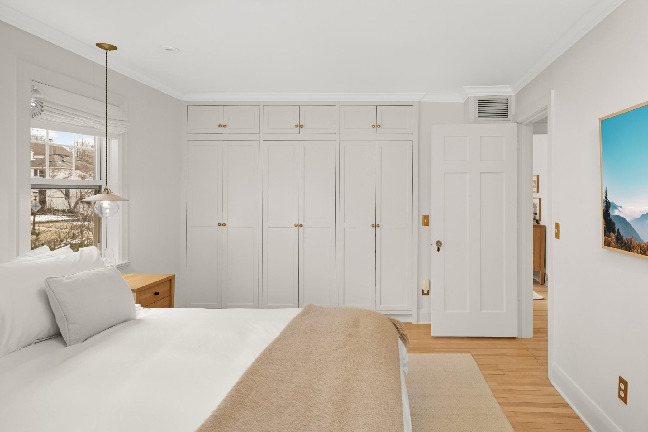 Closets have custom organization systems and lighting