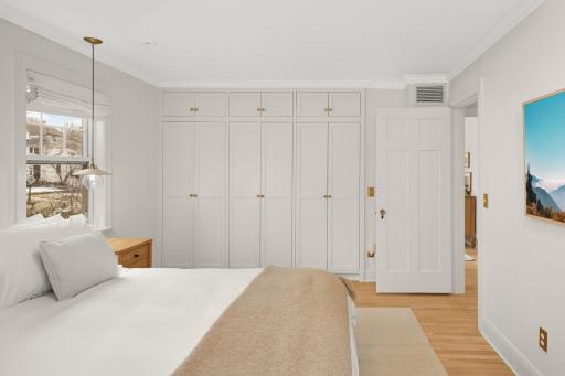 Closets have custom organization systems and lighting