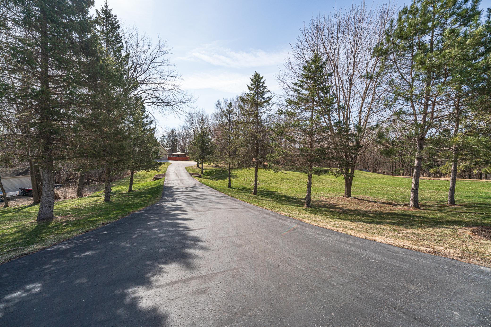 The drive into the property is tree-lined, giving this homesite a sense of country and privacy.