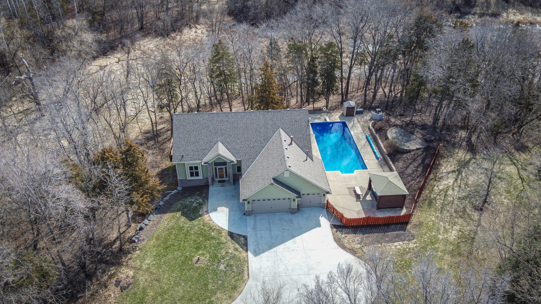 This VERY PRIVATE 5BR 3BA home is an outdoor enthusiast’s dream, with an IN-GROUND POOL and wooded trails and wetlands!