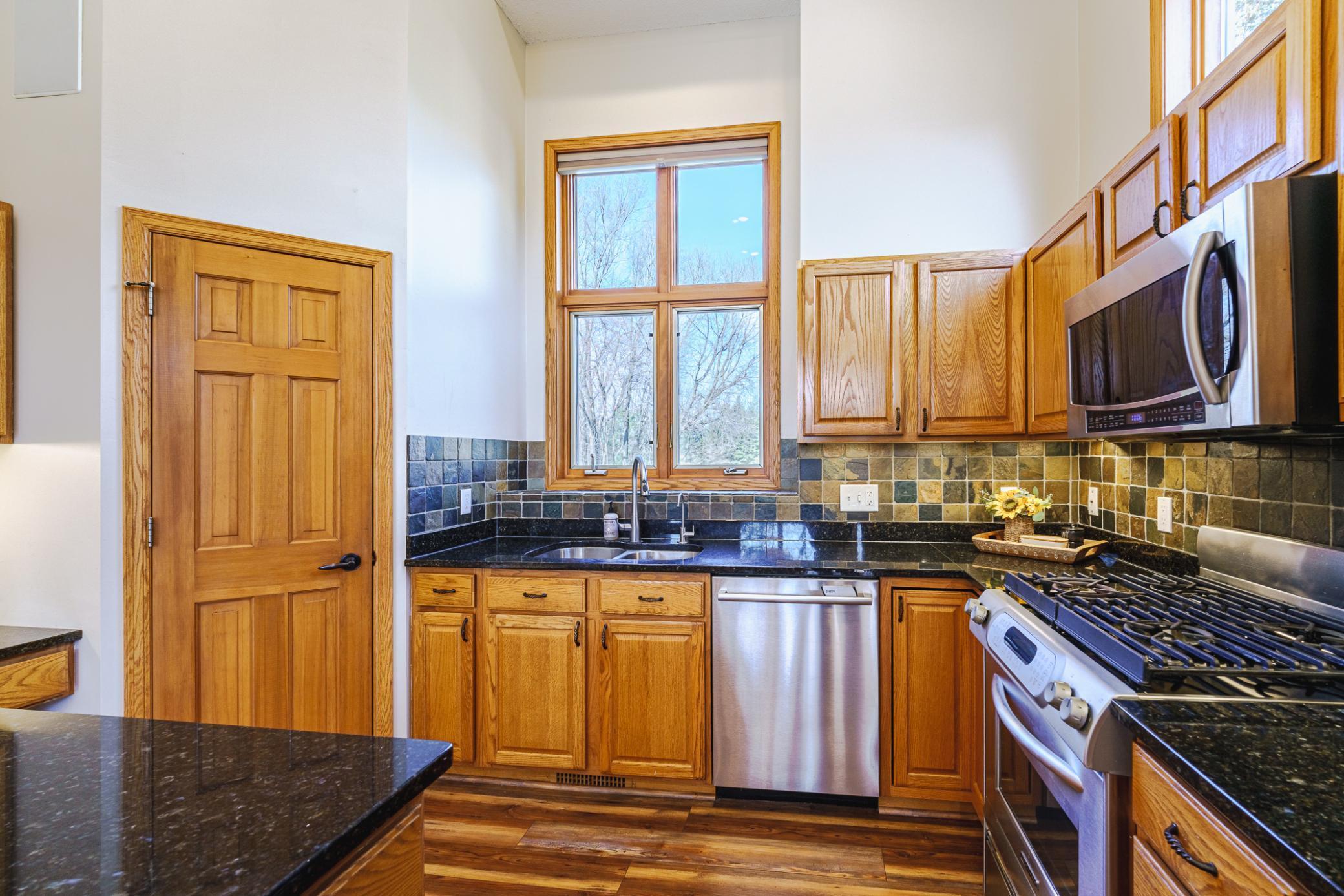 The kitchen storage includes raised panel cabinets and a corner pantry.