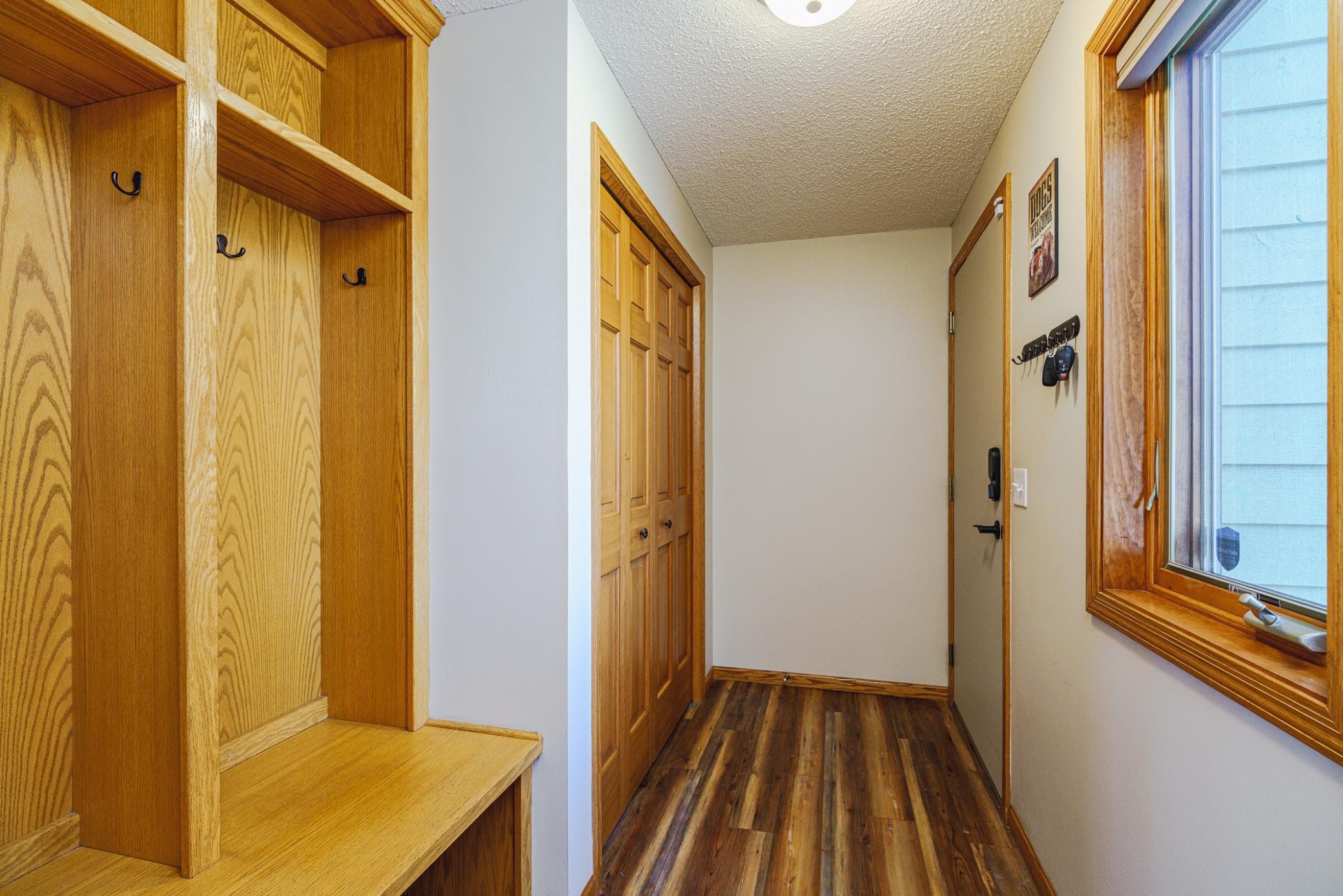 The mud room leads to the garage. This room has a bright window, lockers with hooks and cubbies, and a coat closet.