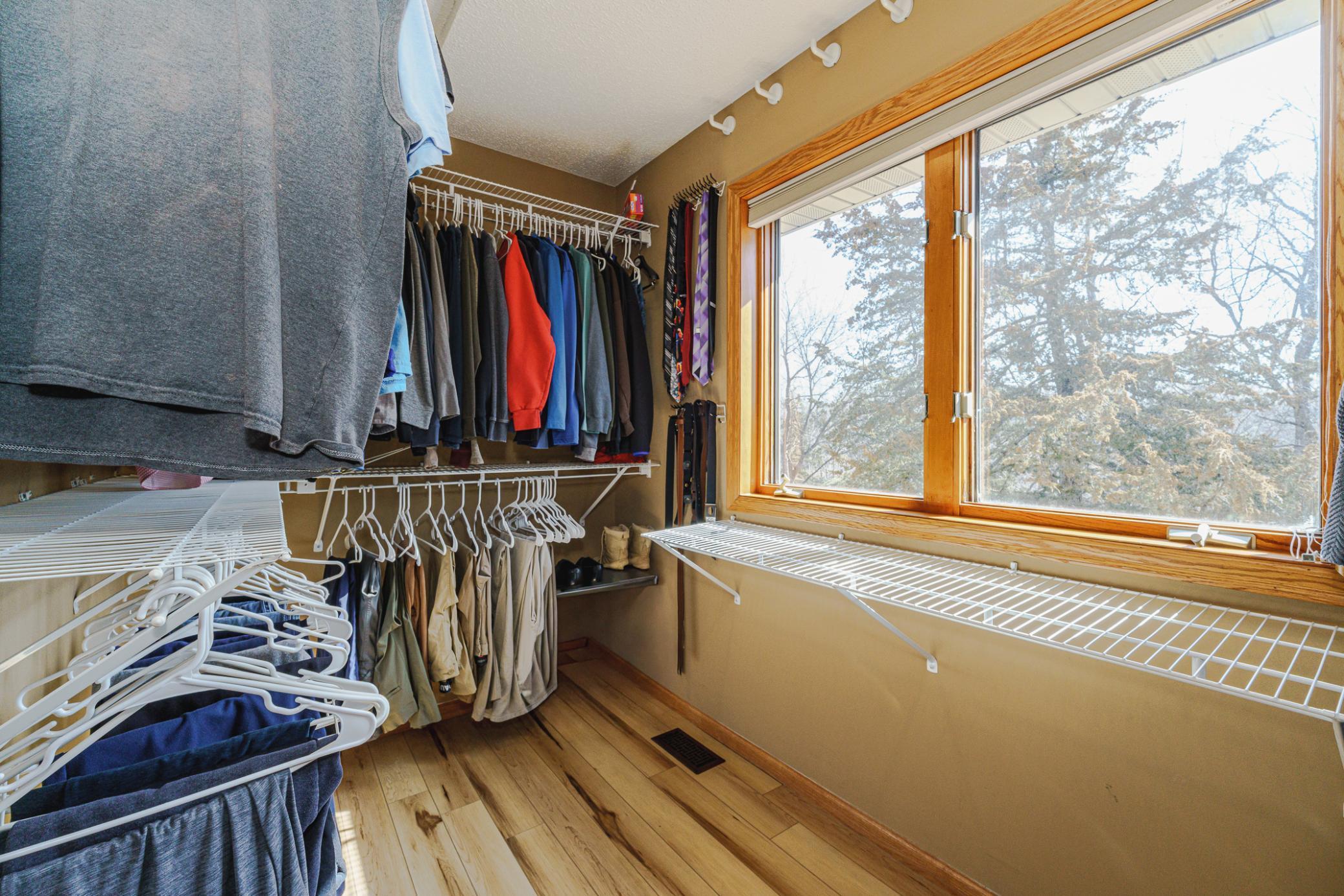 The primary suite walk-in closet has an operable window and pocket doors.
