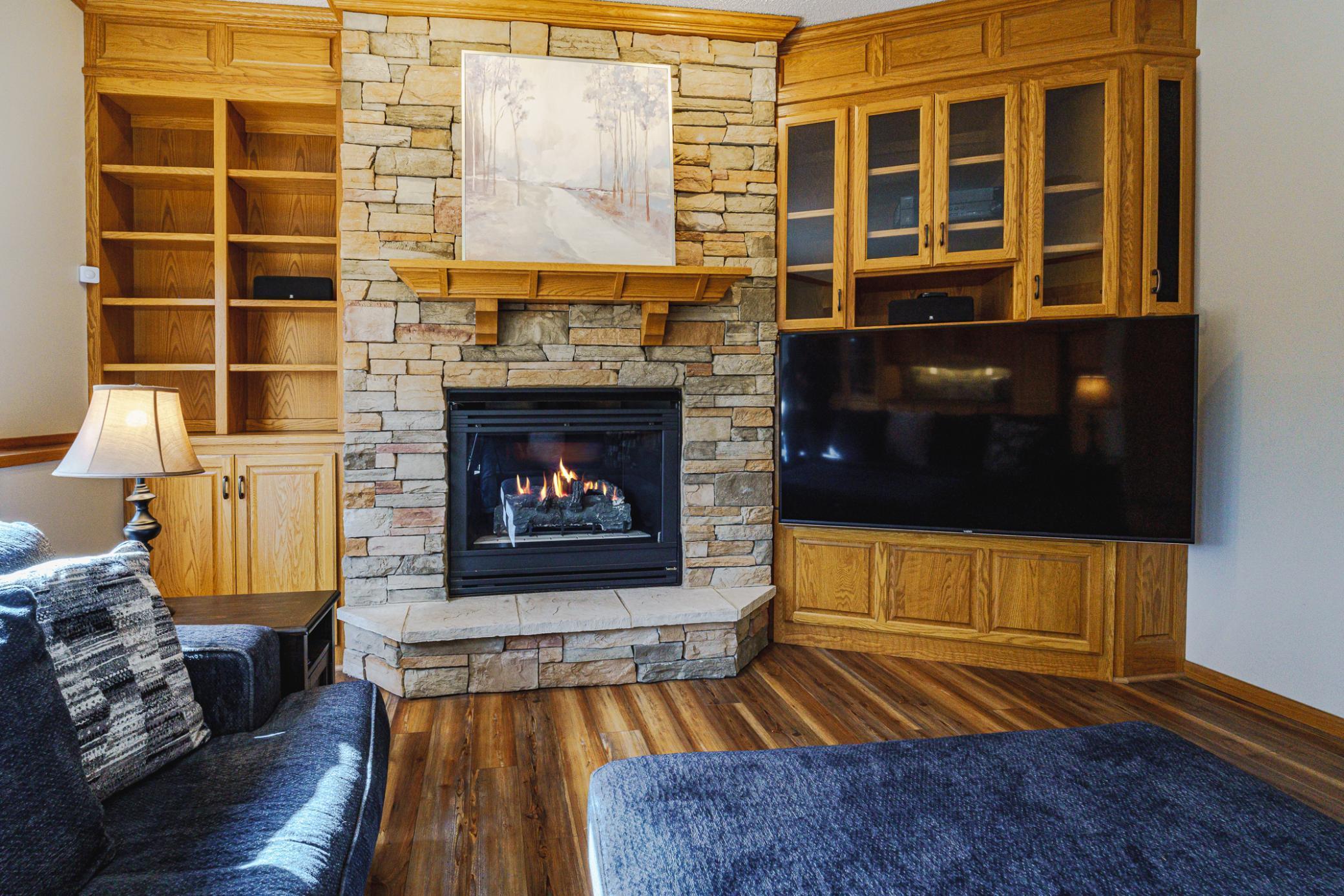 The first lower level family room has one of the three fireplaces in this home.