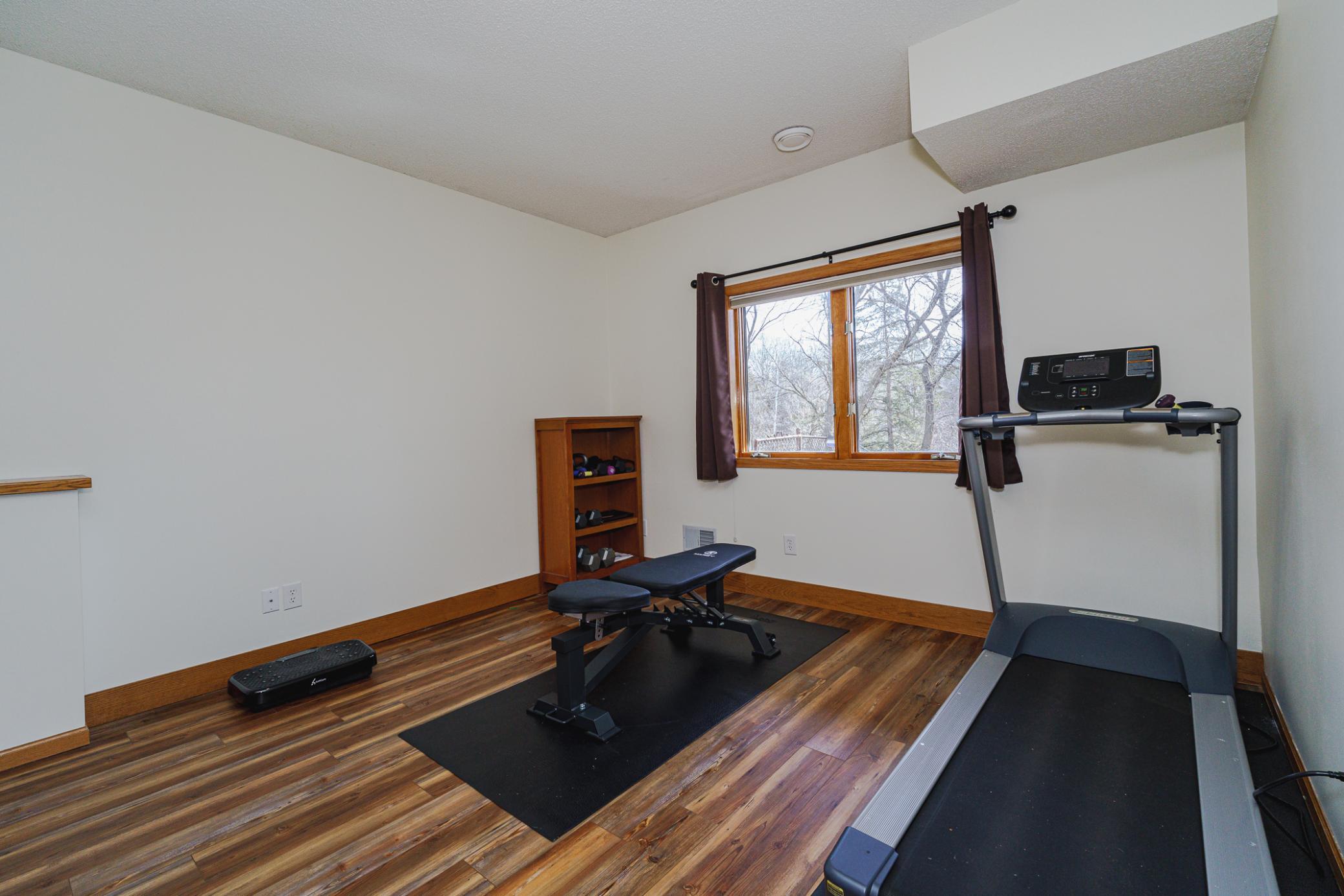 These two large bedrooms have daylight windows. Both bedrooms overlook the tranquil wooded yard. This one is used as a home gym.