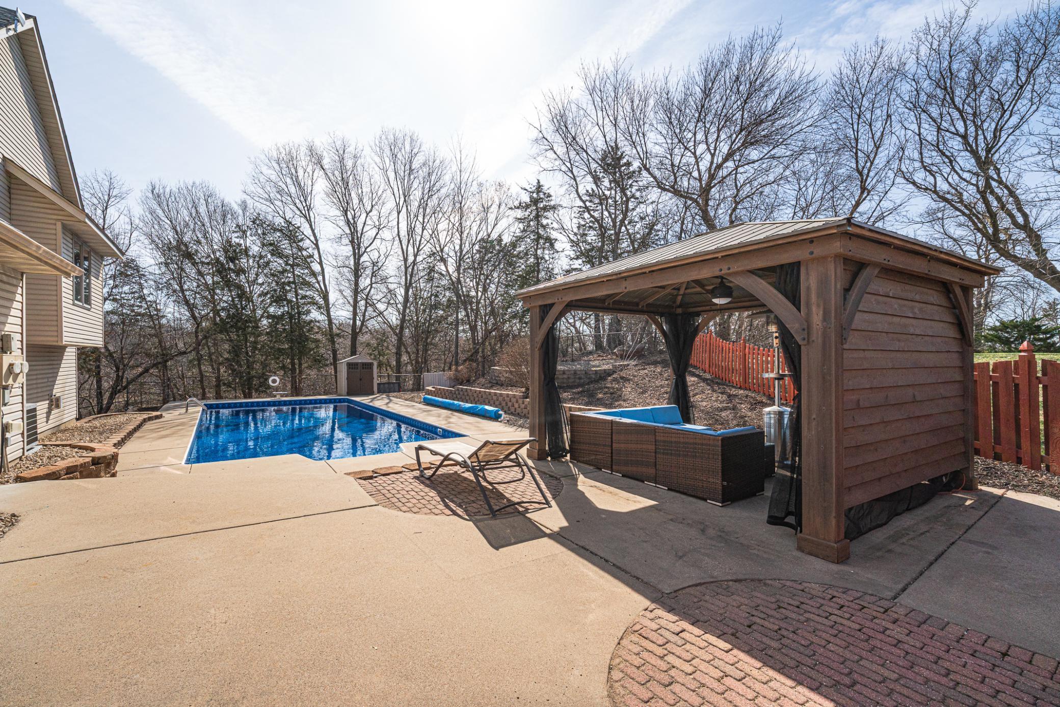 The pool area includes this gazebo with an 83” TV and ceiling fan.