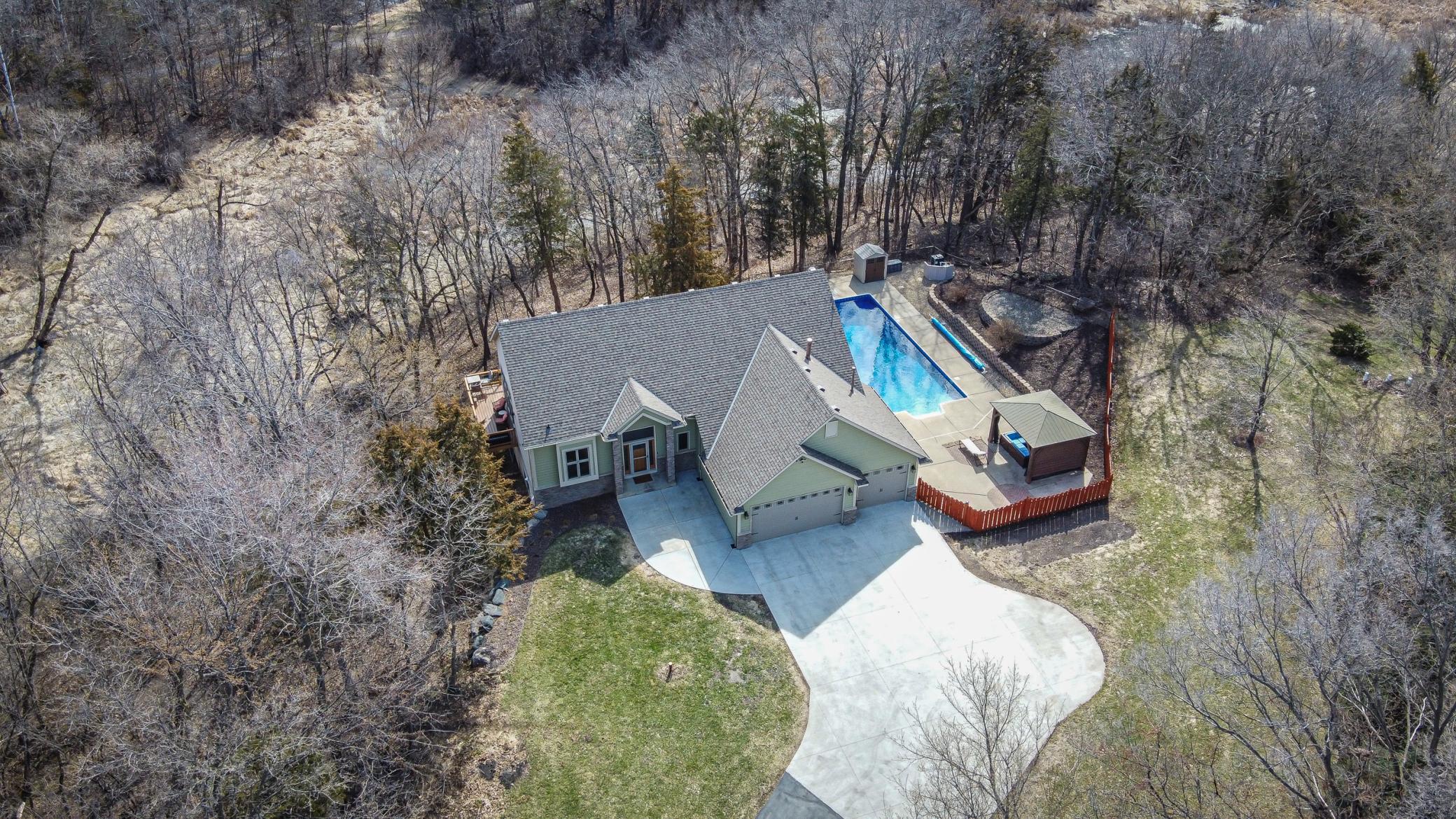 Aerial view of the driveway with its additional parking space, and the in-ground outdoor pool.