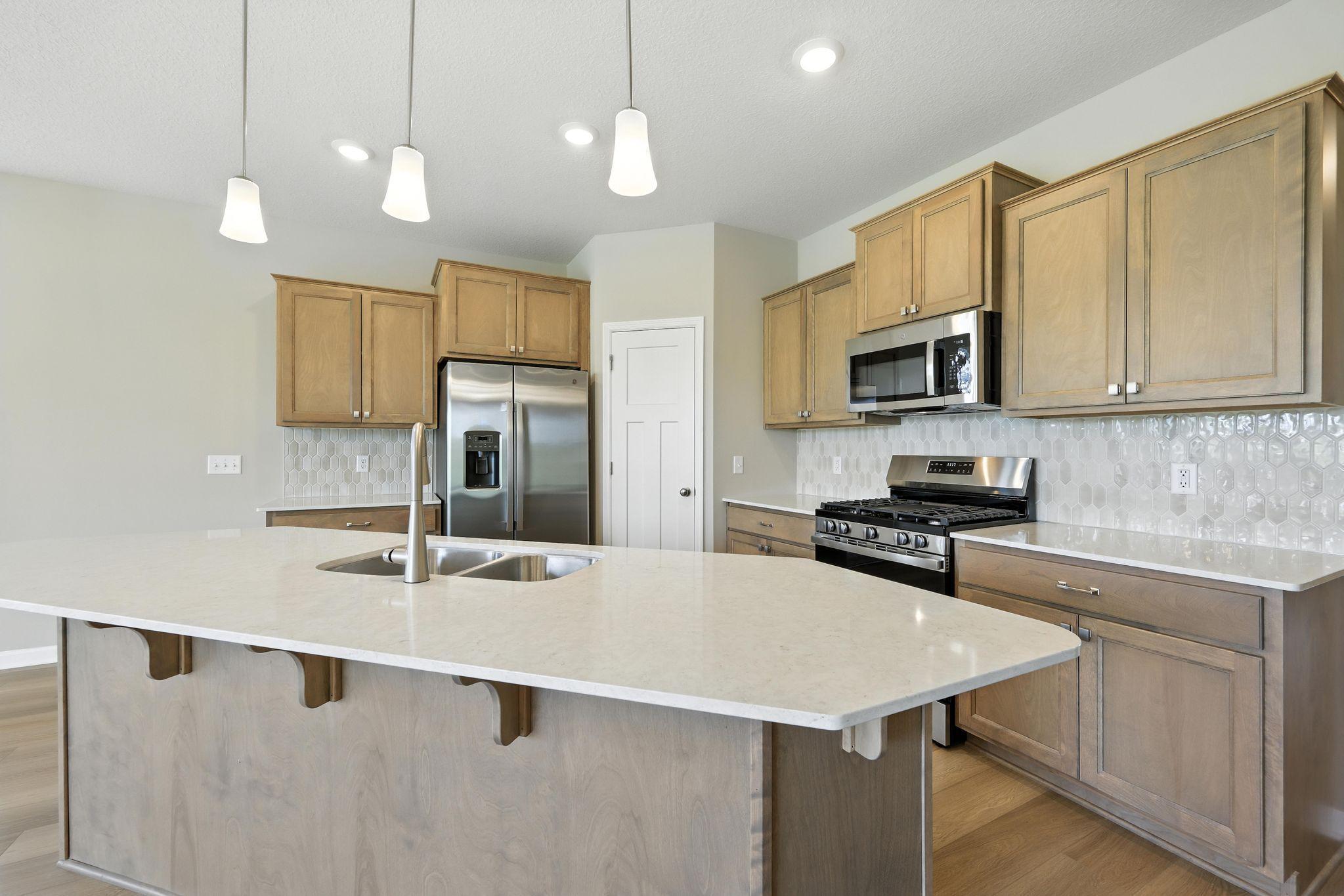 Kitchen *Photo of a previously built home of the same floor plan. Finishes/options may vary.