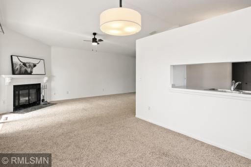 Bright living room with cozy fireplace, informal dining area and pass through kitchen.