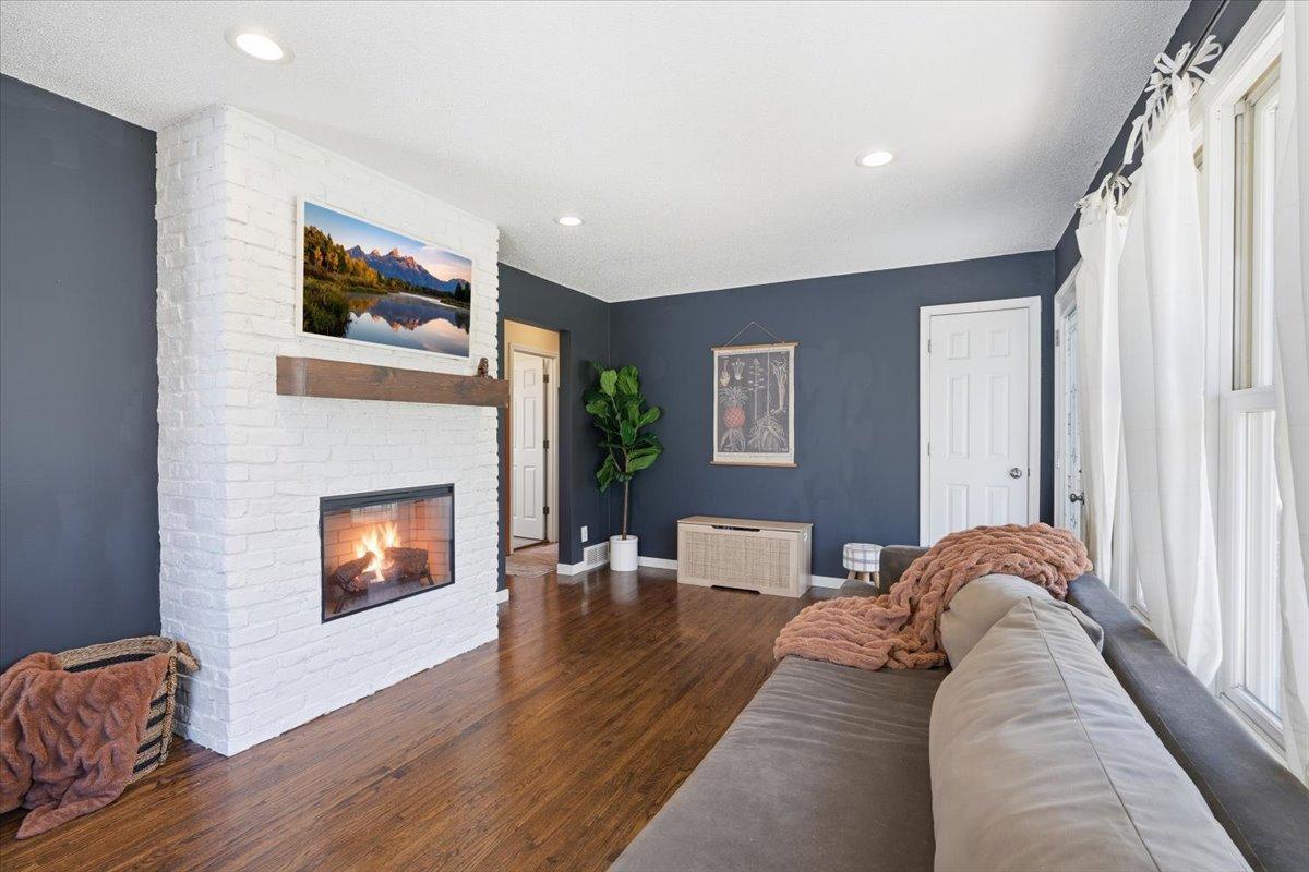 Brick fireplace is the stunning centerpiece of the living room.