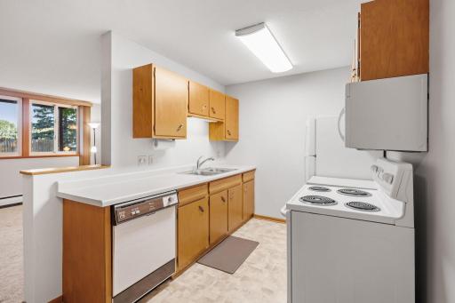 Bright galley kitchen with plenty of cabinet and counter space.