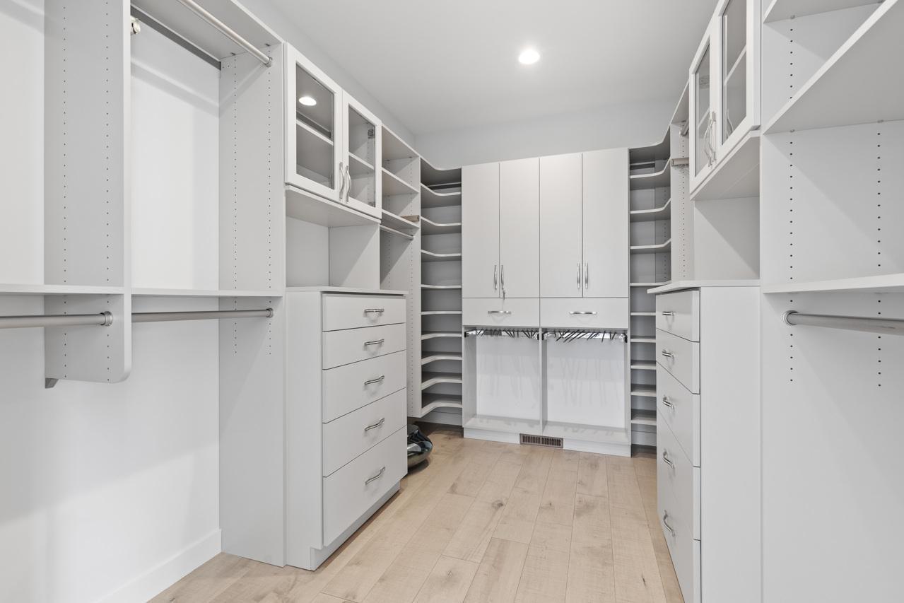 Primary walk-in closet with custom lighting
