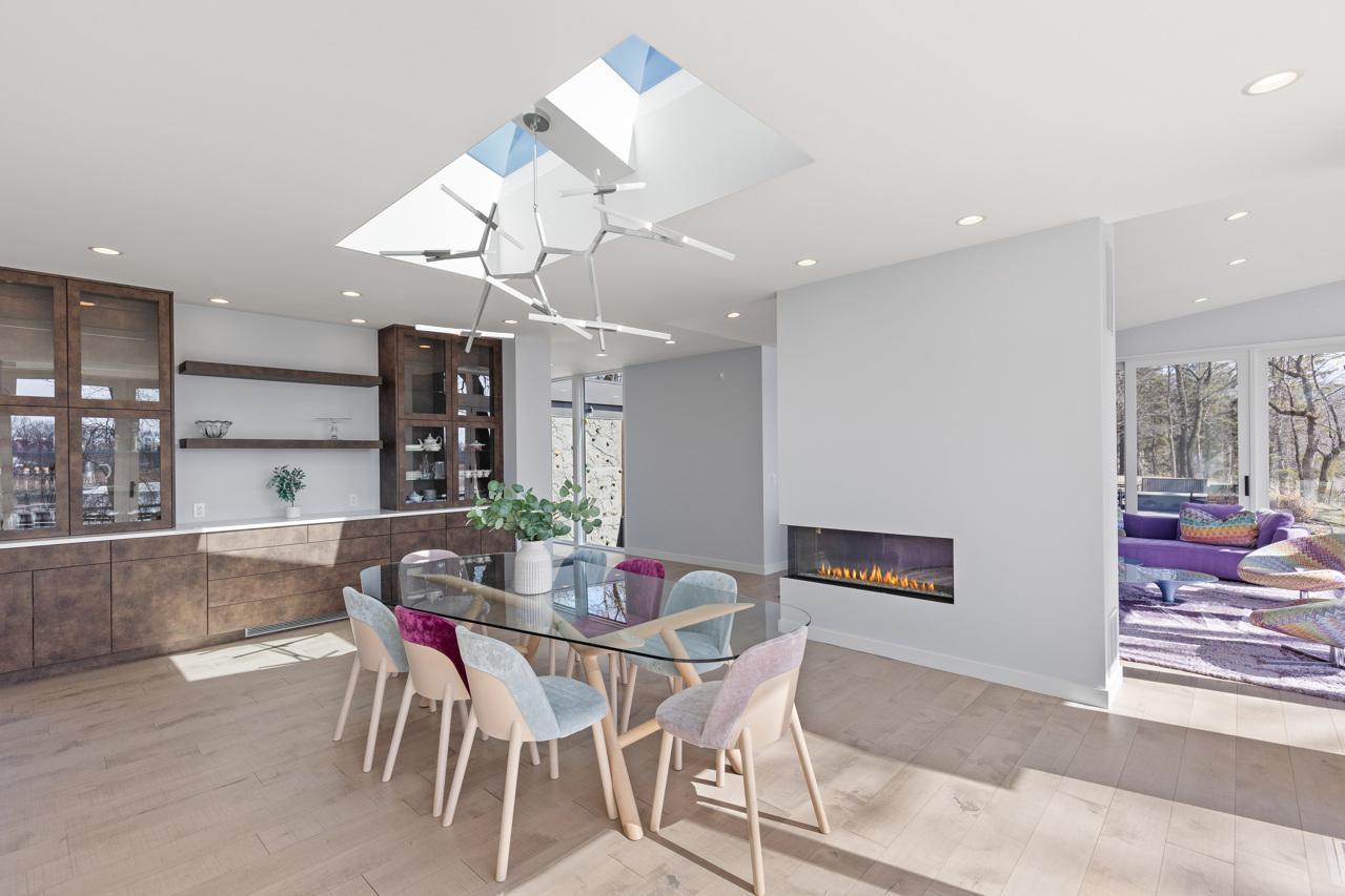 Formal dining room with custom built-ins and a three-sided fireplace.