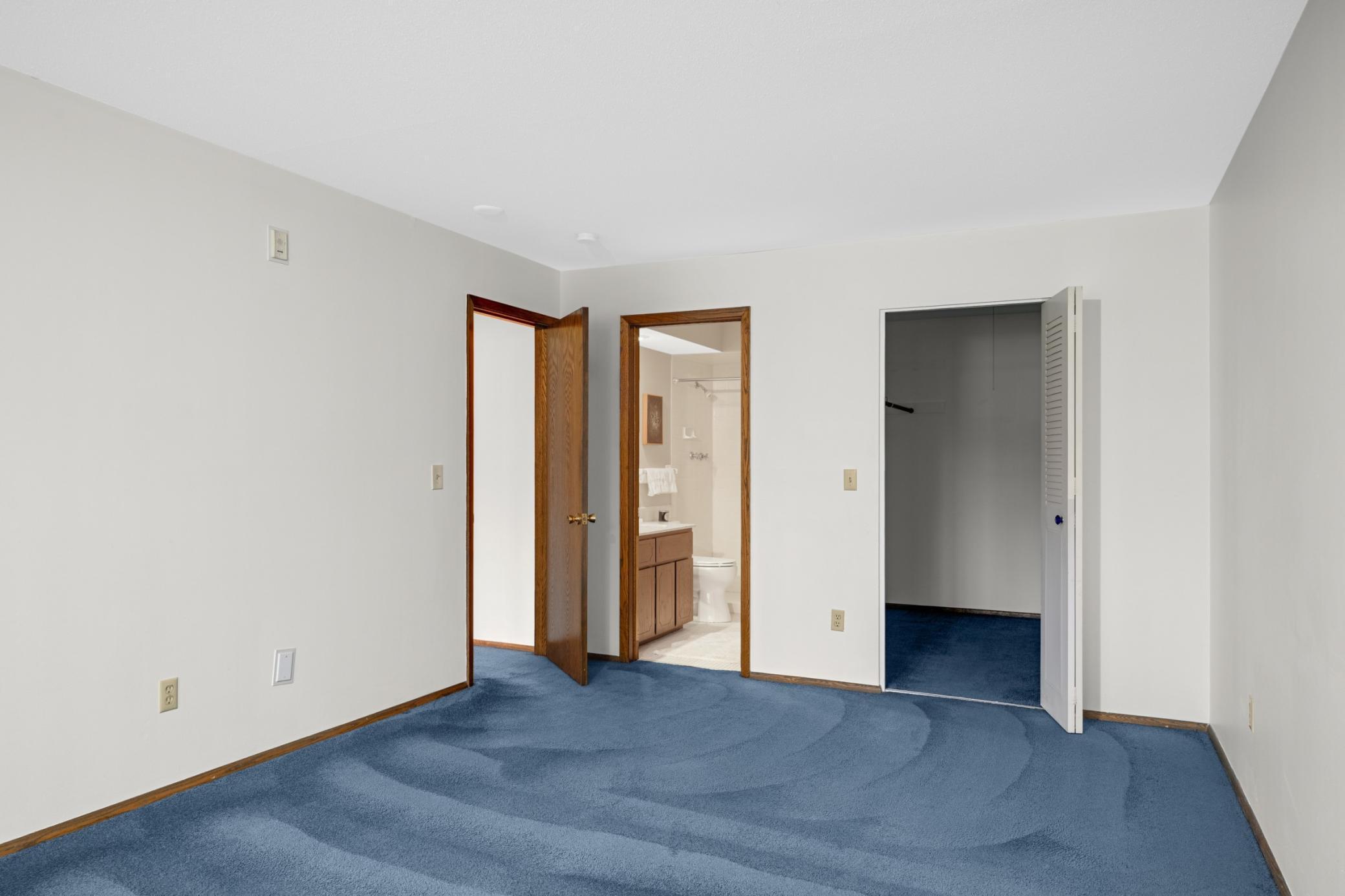 Primary Bedroom 2 toward walk-in closet and en suite bathroom.jpg
