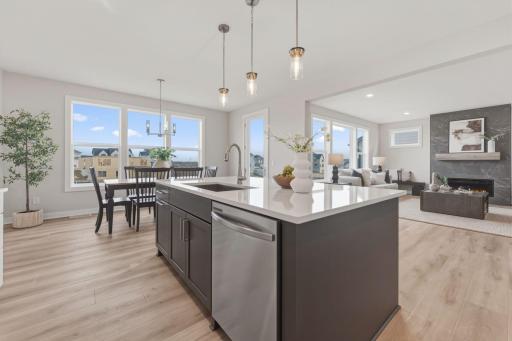 Gourmet kitchen with wall oven and microwave, gas range and built-in hood vent with upgraded stainless steel appliances
