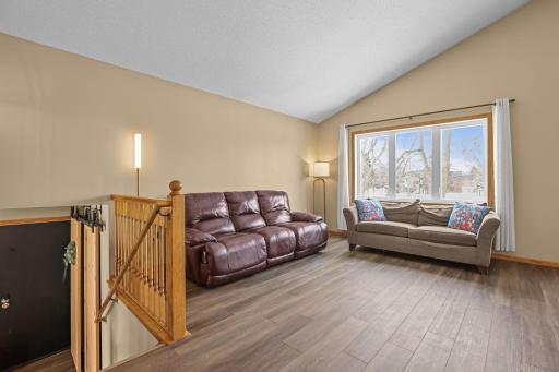 Great room with vaulted ceilings and large windows