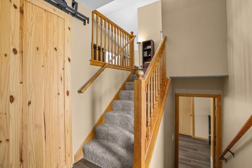 Inviting foyer with newly carpeted stairs and all new floors throughout entire home