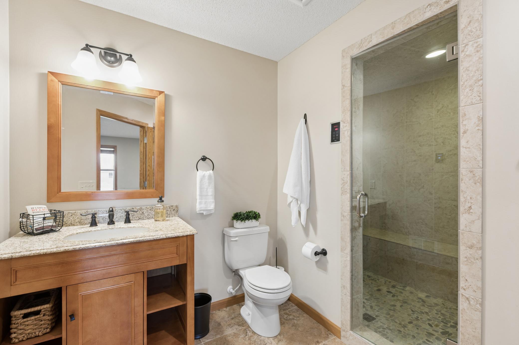 Lower level 3/4 bath features a $15,000 steam shower!