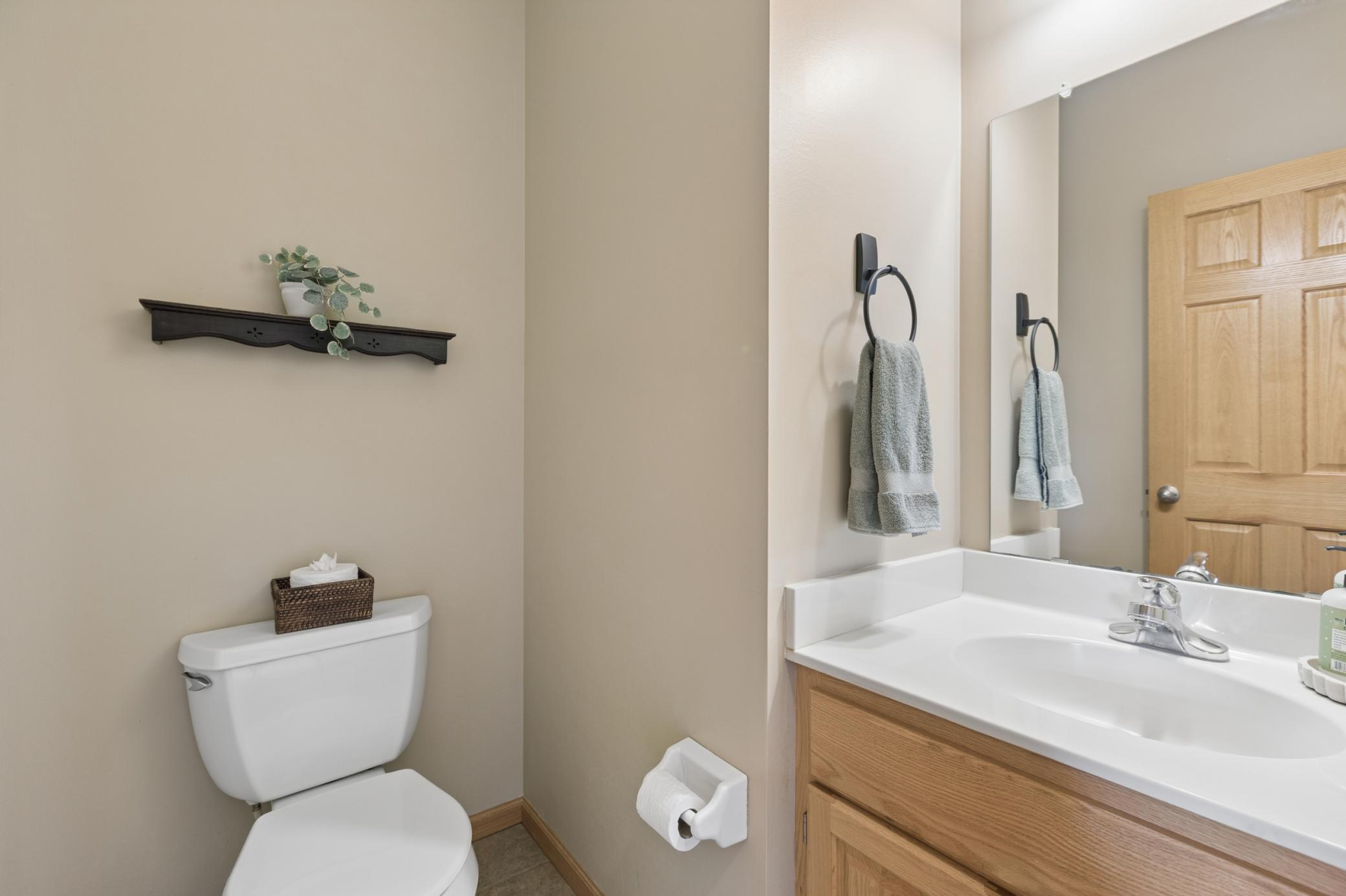 Main floor 1/2 bath located conveniently between the kitchen and garage.