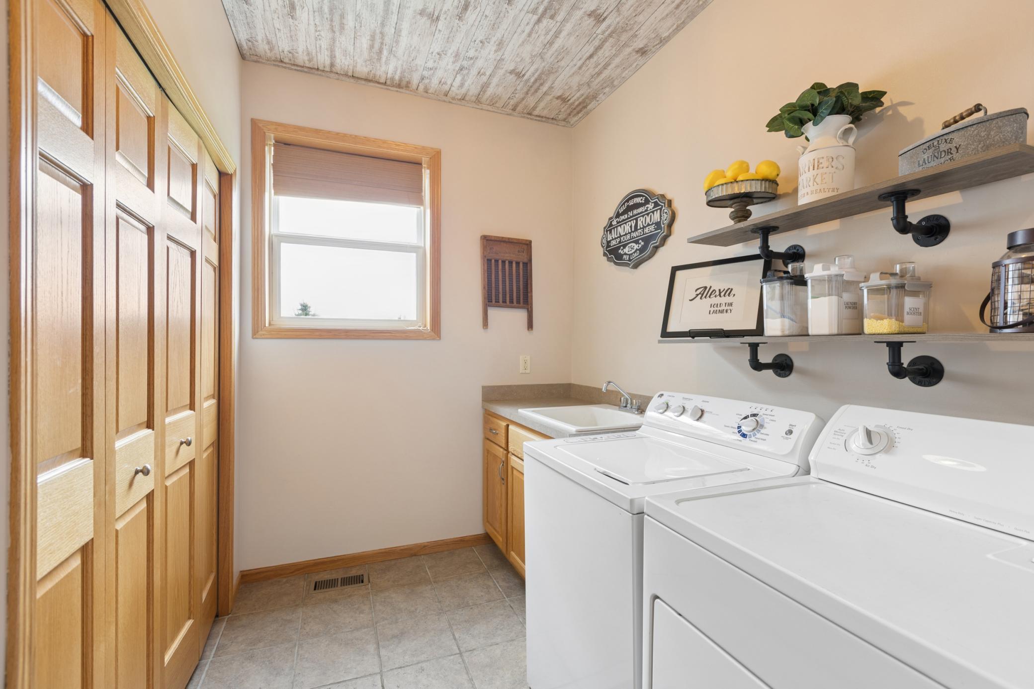 Main level laundry room is conveniently located between the garage and kitchen.