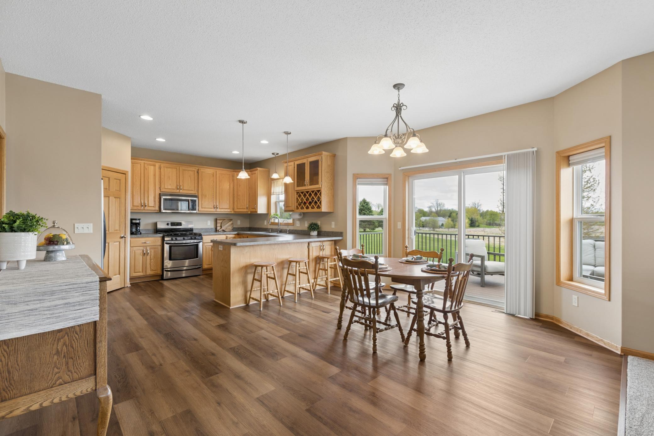 Spacious dining room features a bayed window and deck leading to the backyard.