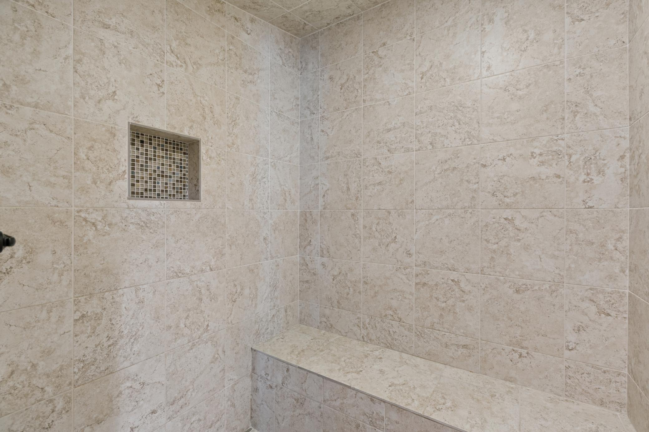 Steam shower is tiled with a top quality control panel.