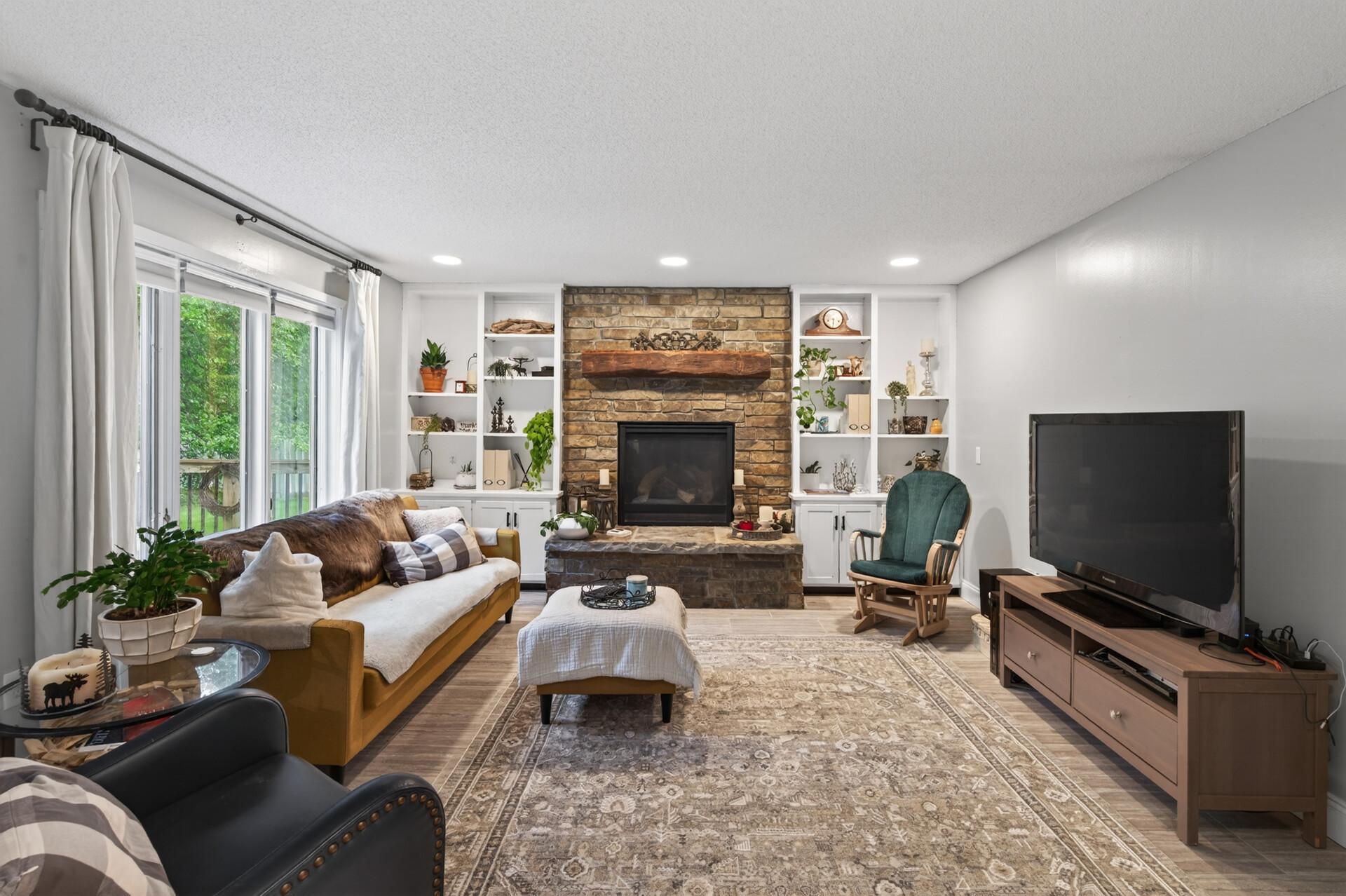 Main level living room complete with gas fireplace.