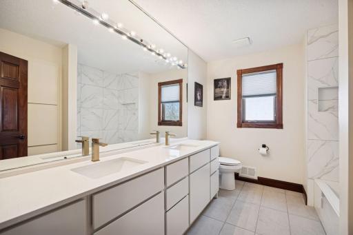 Enjoy a remodeled upper-level bath complete with dual sinks for convenience and style.