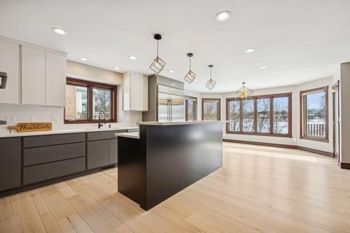 The expansive kitchen includes a breakfast counter and an inviting informal dining space, perfect for everyday meals.