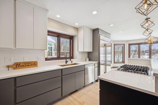 The updated kitchen offers new countertops and a Sub-Zero refrigerator, combining modern style with premium functionality.