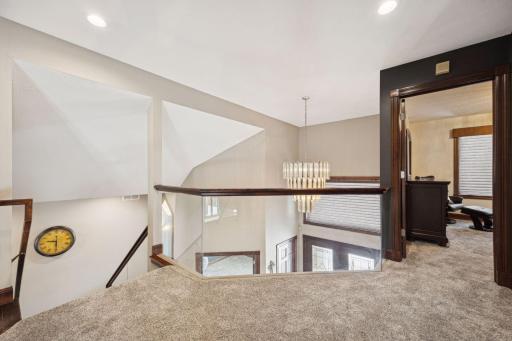 An open catwalk above the foyer provides a dramatic view and access to the upper-level bedrooms.