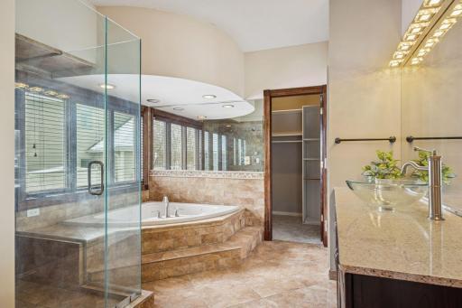 The primary bath offers a spa-like soaker tub and a spacious walk-in closet for ultimate convenience.