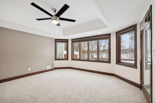 The lower-level bedroom walks out directly to the patio and pool, offering convenient outdoor access.