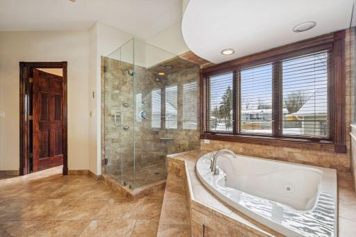 Primary bathroom with a glass-enclosed shower and ceramic tile finishes.