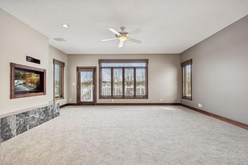 The spacious primary bedroom offers private access to the main deck, perfect for morning coffee or evening relaxation.