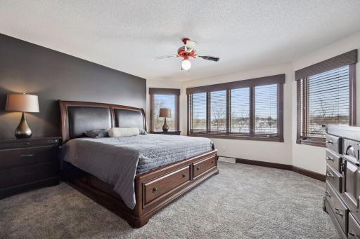 The upper-level bedroom overlooks the pond, providing peaceful, nature-filled vistas right from your window.