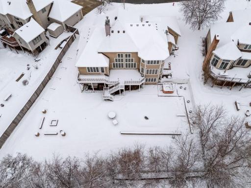 Walls of picture windows fill the home with natural light while showcasing beautiful views of the pool and pond.