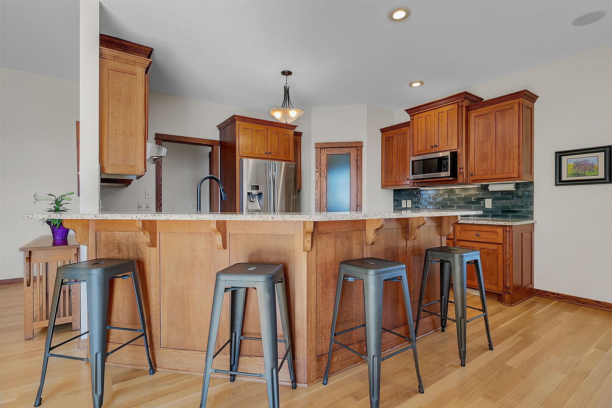 A functional two-tier peninsula that adds extra dining space and easily accommodates four bar stools—ideal for meals, snacks, or gathering with friends.