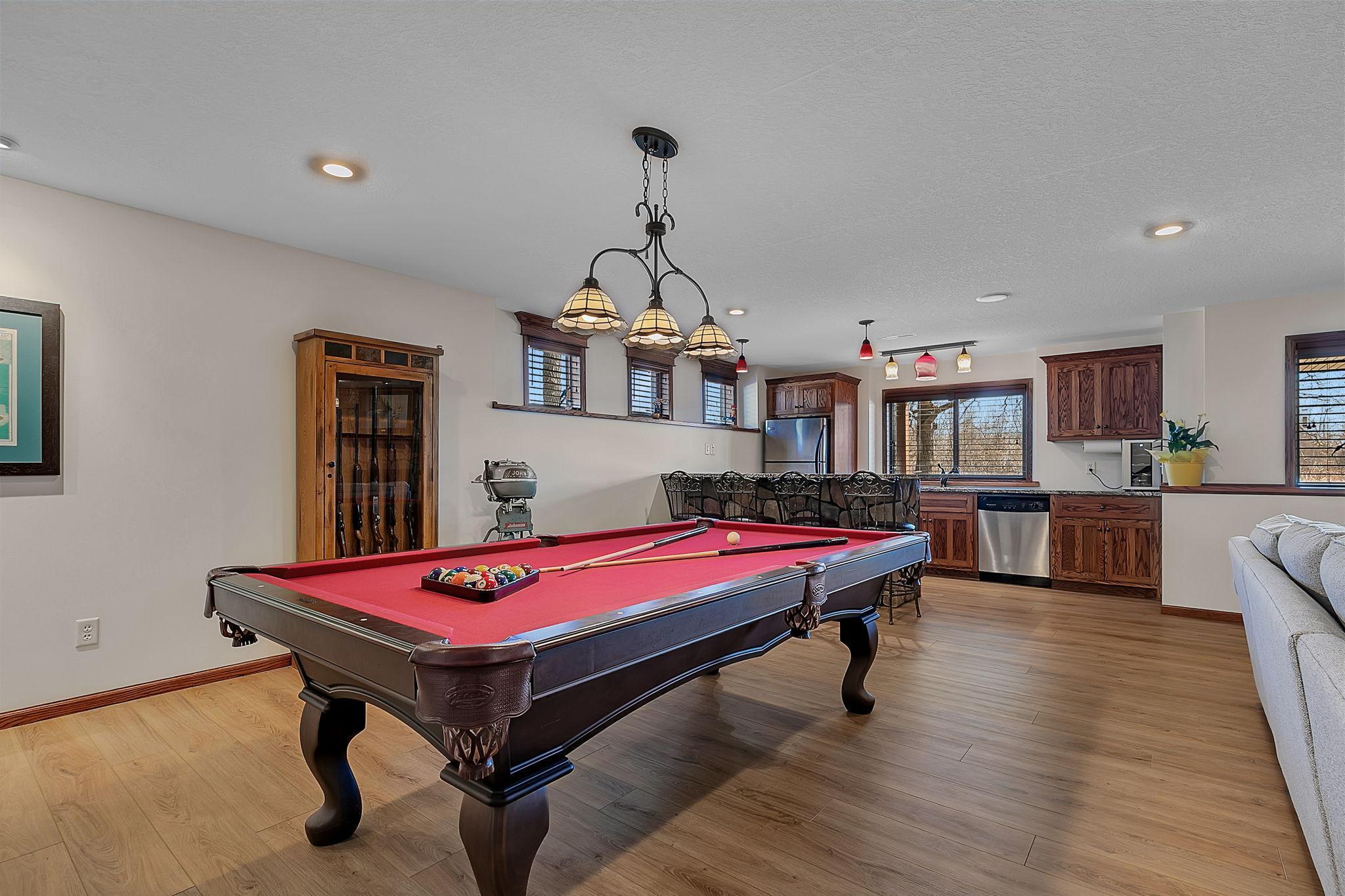 The game area sits conveniently next to the bar, creating a seamless space perfect for entertaining and socializing.