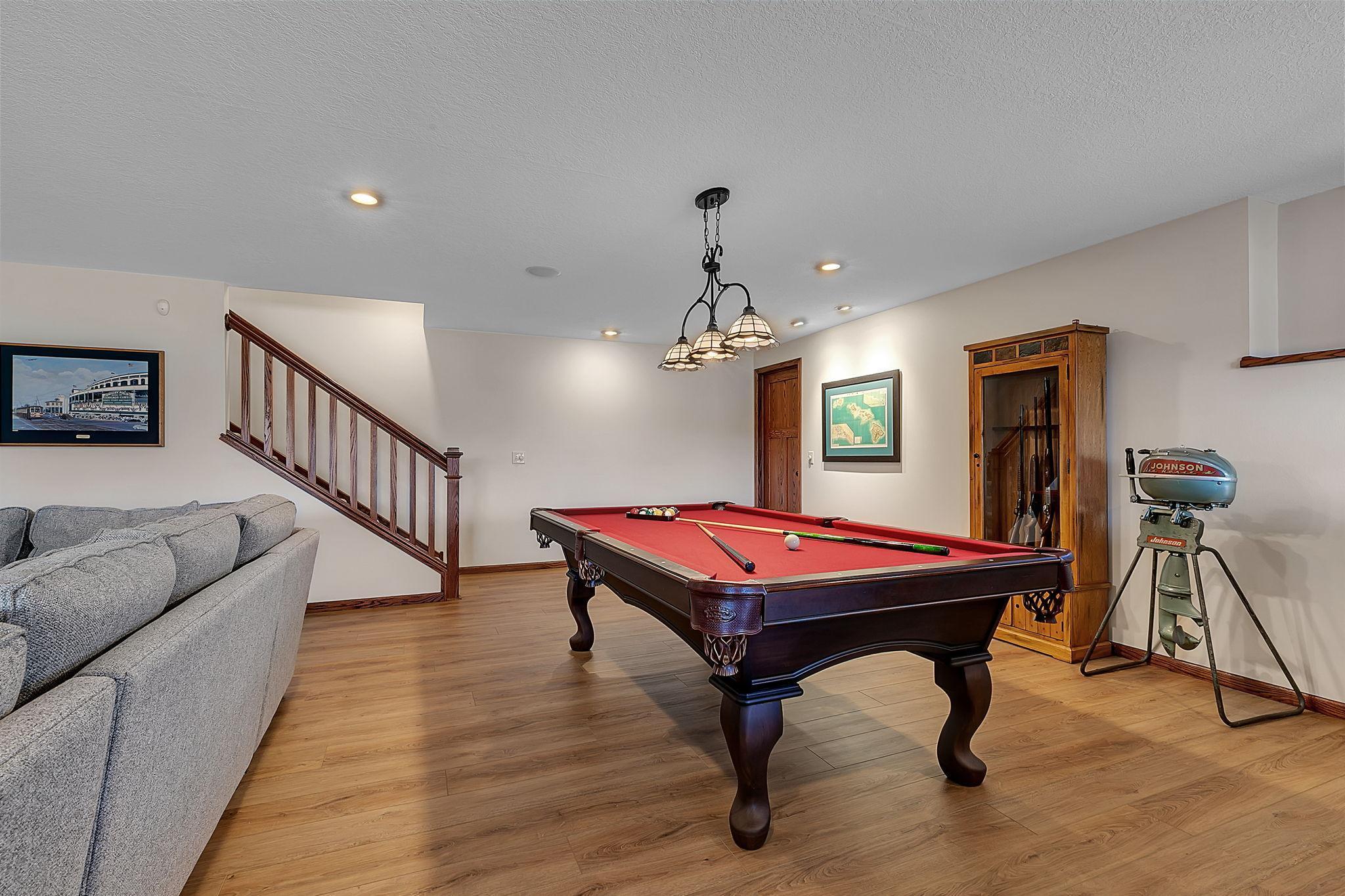 Here’s another look at the adaptable lower level space, currently arranged as a billiard area, ideal for fun, gatherings, or a custom setup of your choice.