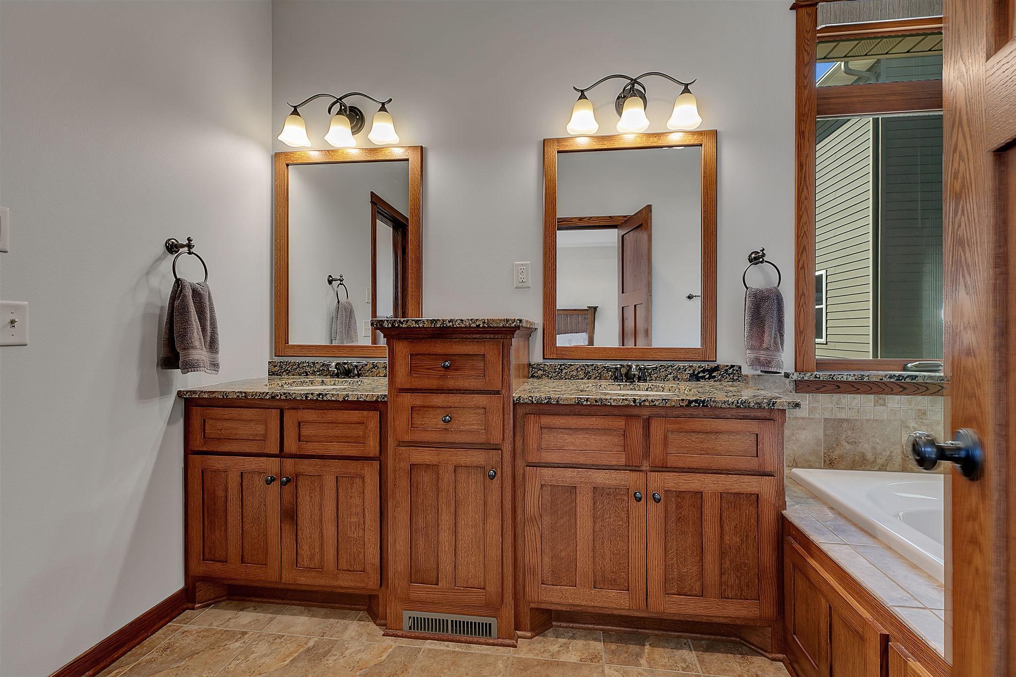 This luxurious private ensuite boasts a dual vanity, separate shower and toilet, and a generous soaking tub, combining style and functionality.