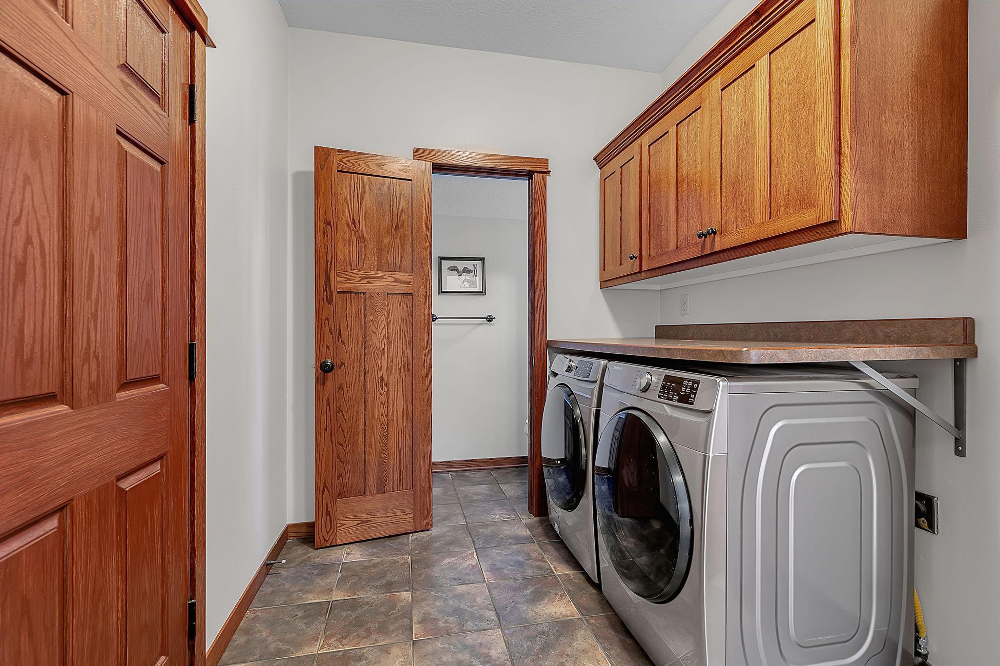 Thoughtfully designed mudroom off the garage featuring main-level laundry and a handy half bath. Offering easy access and everyday convenience.